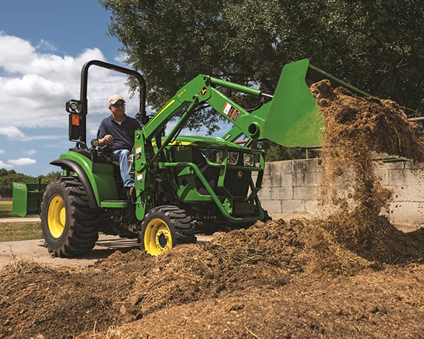 2 series compact utility tractor shoveling dirt