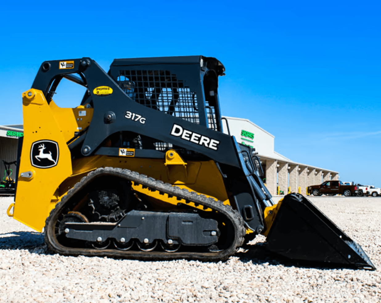 317g track loader scooping gravel on a construction site